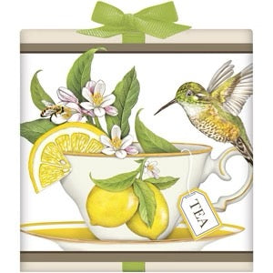 Packaging design with a teacup, lemons, and a hummingbird on a white background