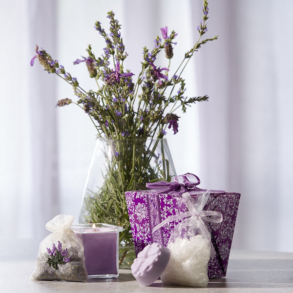 Purple lavender take out box with much of lavender salts, small lavender candle, pouch of lavender seeds, small round flower lavender soap