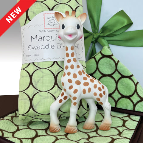 Gift box for babies includes Sophie the giraffe a chewable giraffe tow, swaddle blanket green with brown circles and 2 cotton velour washcloths green with  brown circles.  white gift box with green satin ribbon