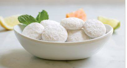 A box of lemon tea cookies covered with a light powdered sugar